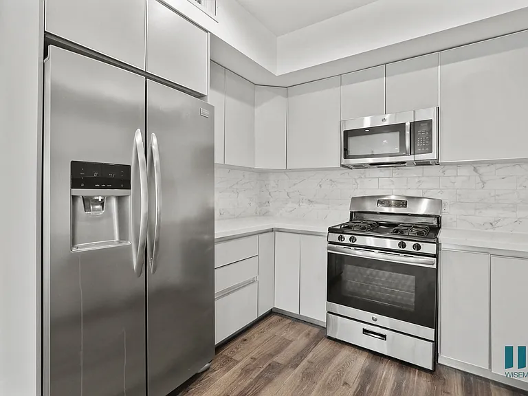 Kitchen with Stainless-Steel Refrigerator, Stove, and Microwave Oven