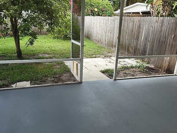 Private screened in patio in fenced backyard.