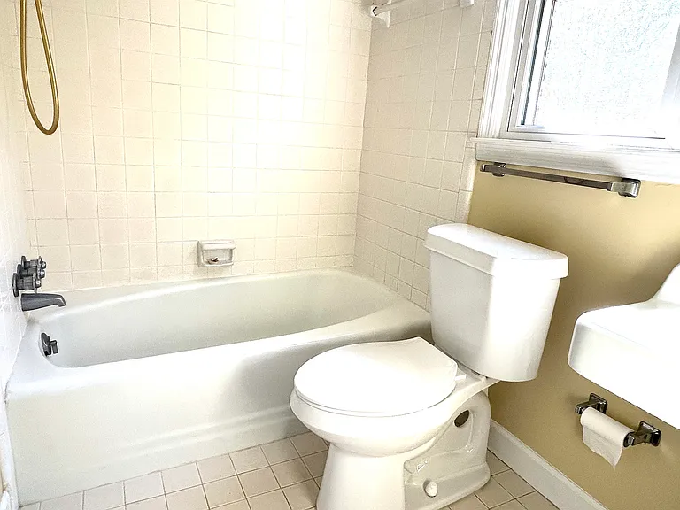 The main bathroom with a bathtub and a shower and closet in the upstair master bedroom.