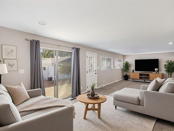 Family Room *House is unfurnished and virtually staged to show possibilities. Lights, Window Treatments, Wall/Ceiling Colors and Flooring are Accurate.*