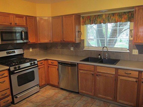 Spacious, sunny kitchen with gas range and microwave.
