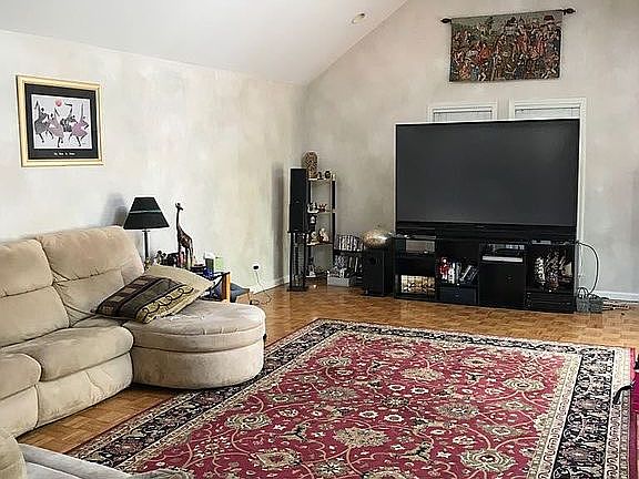 family room with Vaulter ceilings and sky light