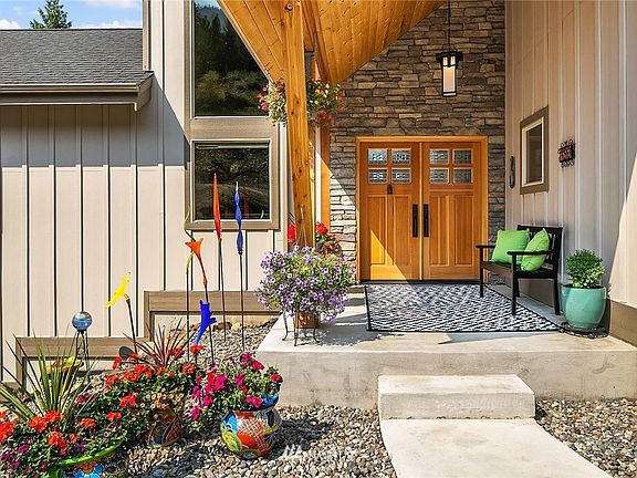 Gorgeous Douglas Fir double door with stone surround at entry.
