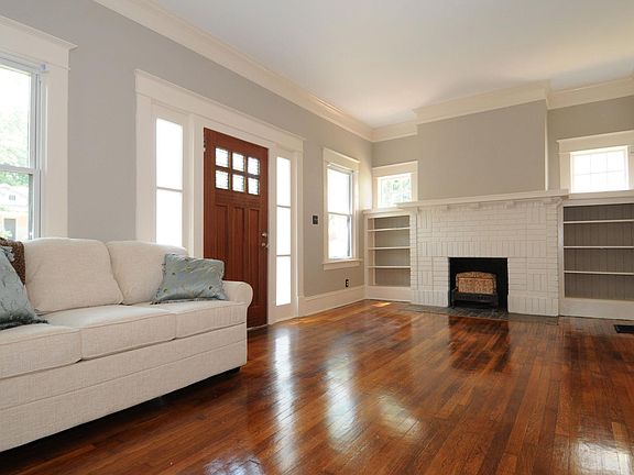 Front room with original floors and built-ins around the fireplace.