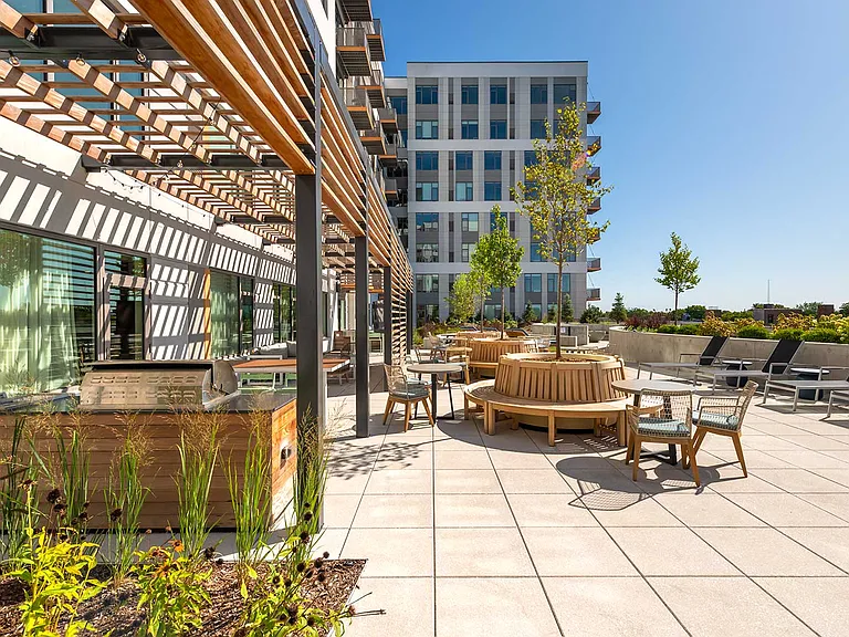 Unwind on Eleven33's sun deck complete with lounge seating, fire pits, and grilling stations designed for connection, relaxation, and Oak Park views.