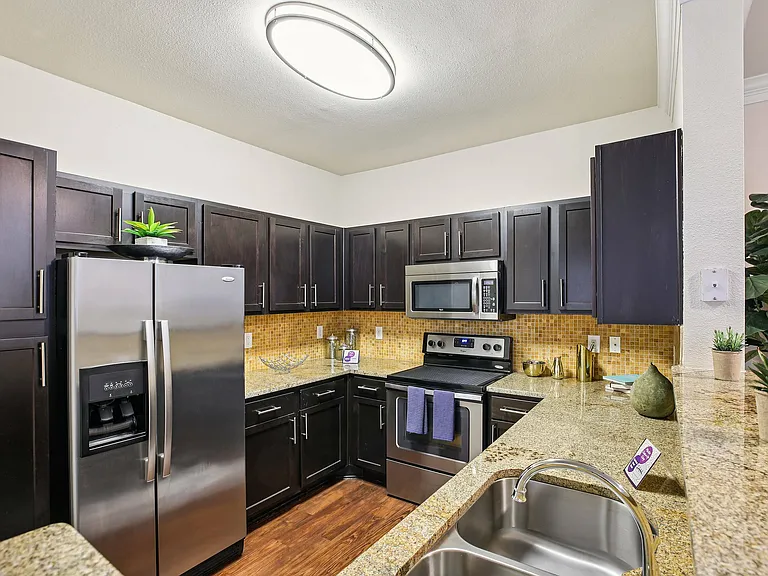 Sleek all-electric kitchen with modern appliances at Providence Uptown in Houston