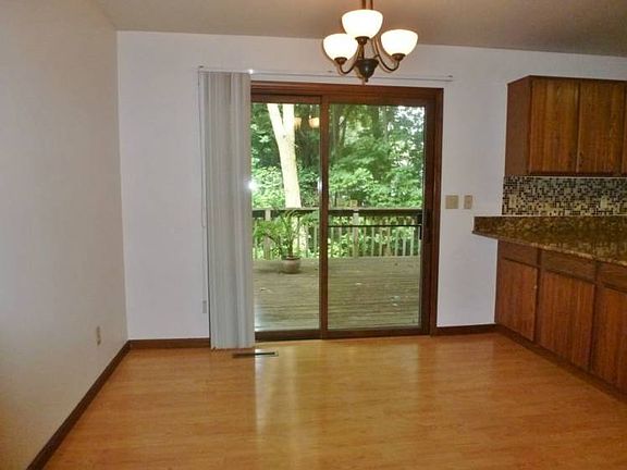 Spacious breakfast area overlooks the deck and hot tub.  Also room to pull up a bar stool at the kitchen peninsula!
