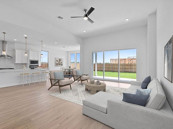 Spacious gathering room in the Boling floorplan with open-concept design and abundant natural light.