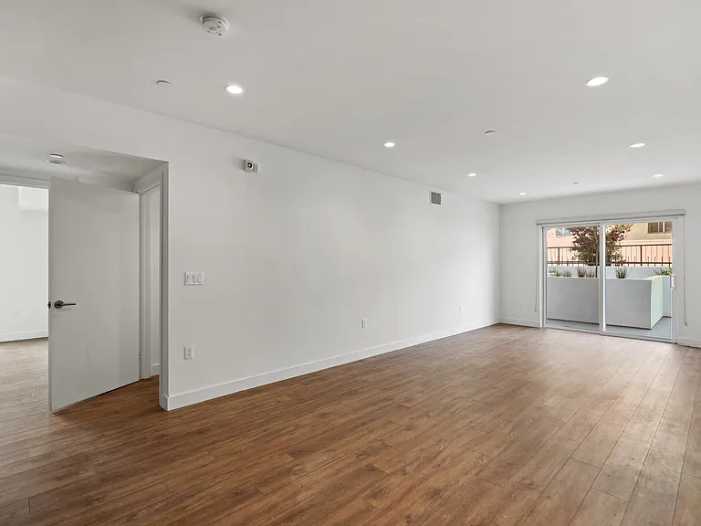 Large-Size Living Room with Vinyl Flooring, Recessed Lighting, and Patio
