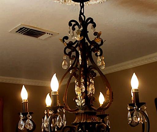 Check out this ornate light fixture above dining room table.