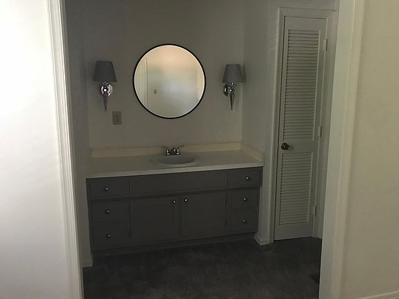 Master bedroom vanity area that leads to a full bathroom. 