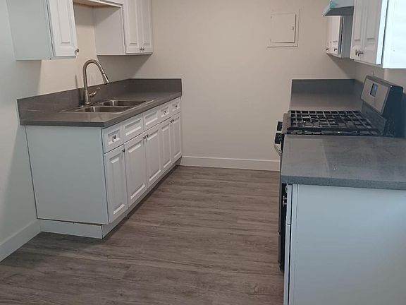 Brand new kitchen with quartz countertops, new stove, sink , flooring
