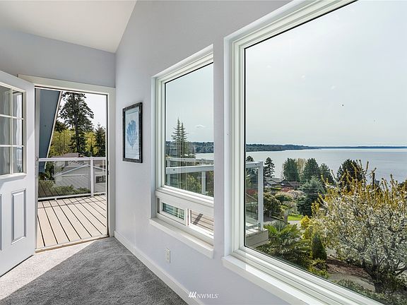 Walk out to deck from primary bedroom with highboy table and chairs for amazing views with coffee or wine!