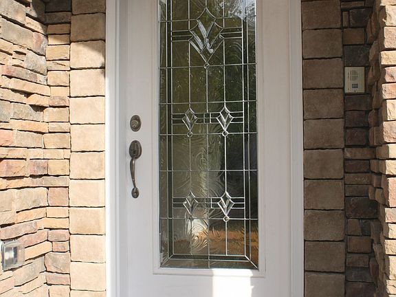 Covered entry and lovely glass door welcome you.
