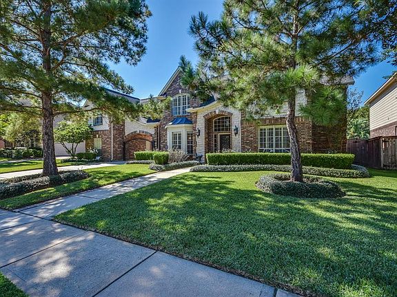 Beautiful Trendmaker Home with Stone and Brick elevation, surrounded by beautiful trees in the premier master planned community of Gleannloch Farms.