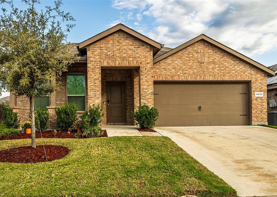 View of front of home with a garage, and a front yard