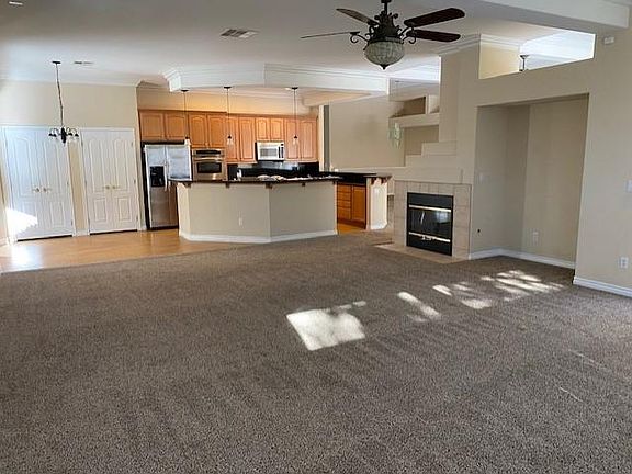 Livingroom toward kitchen with fireplace on right