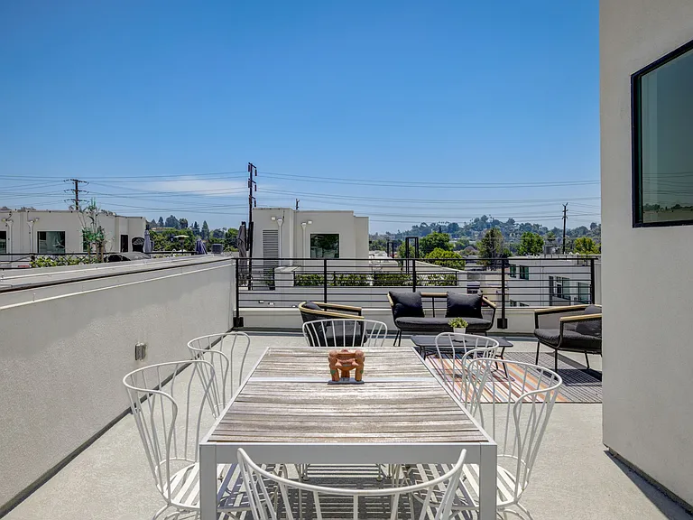 Expansive rooftop deck with mountain views, perfect for entertaining, outdoor dining, and relaxing.