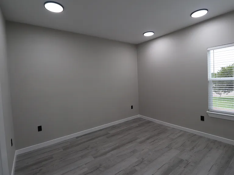 Bedroom 2 of 4 featuring modern flooring, recessed lighting, and plenty of natural light.