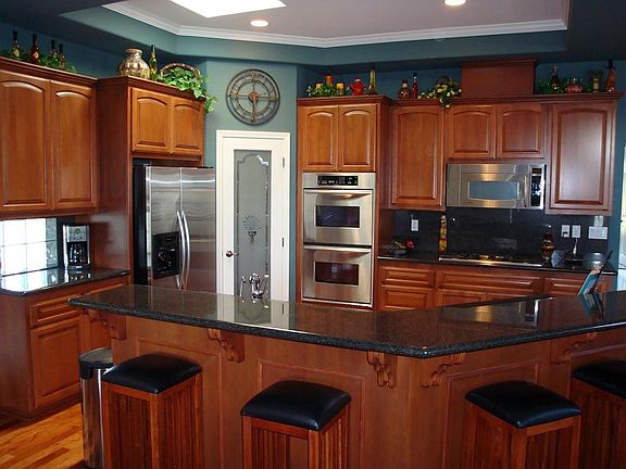 Kitchen with island bar and stainless steel appliances