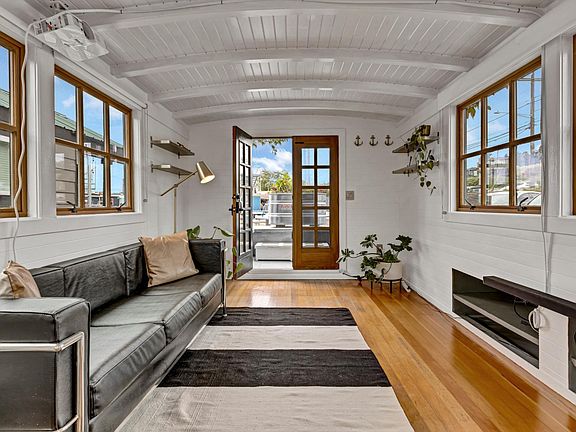 Hardwood floors and French doors. Projector over couch, surround sound speakers, black-out window treatments and pull-down screen for a home theater experience!