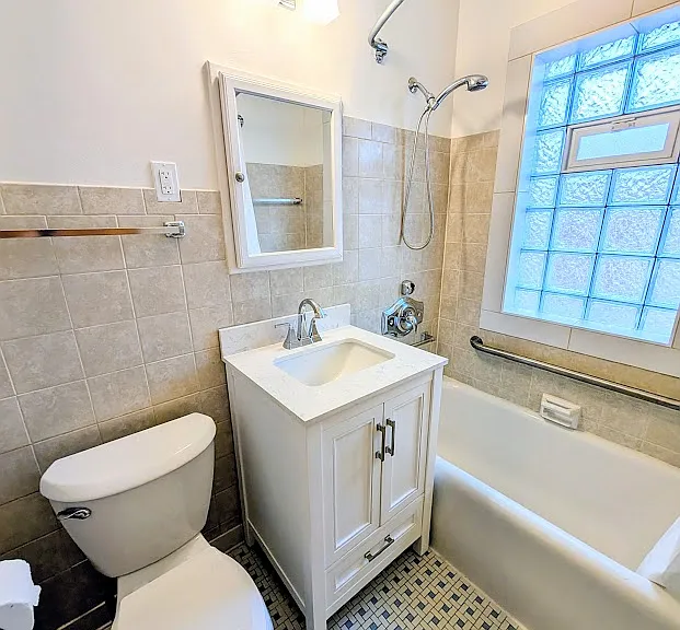 [UPPER UNIT]: bathroom with new vanity, new security block window, and new toilet