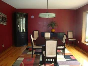 The formal dining room enjoys natural light from the large picturesque window and boasts a modern chandelier. there is plenty of room here for entertaining your extended family for holidays meals.
