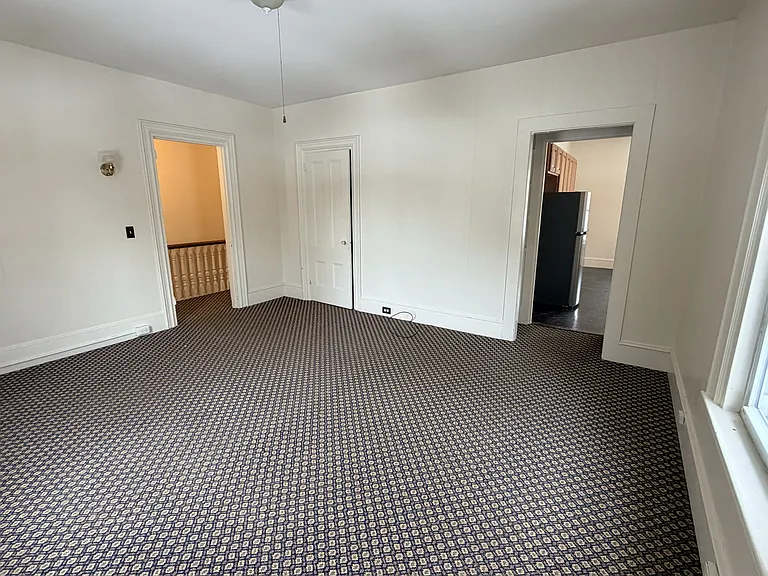 Living room looking into kitchen and hallway
