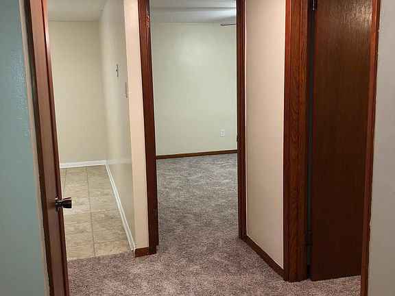 Hallway from living room into bedrooms (2nd bedroom on right side, master bedroom ahead on right) and kitchen (ahead on left). Bathroom and closet on left side.