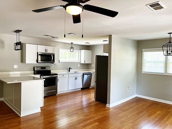 View from open concept living dining area, into the kitchen.