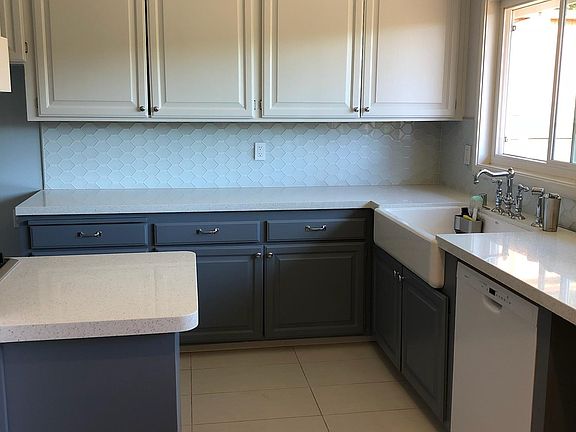 Updated kitchen with quartz counters, gas stove, dishwasher and sink.
