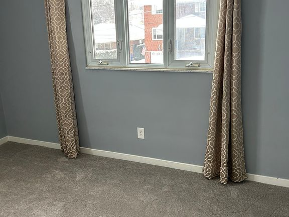 Living room with freshly painted walls and brand-new carpets. All curtains included!