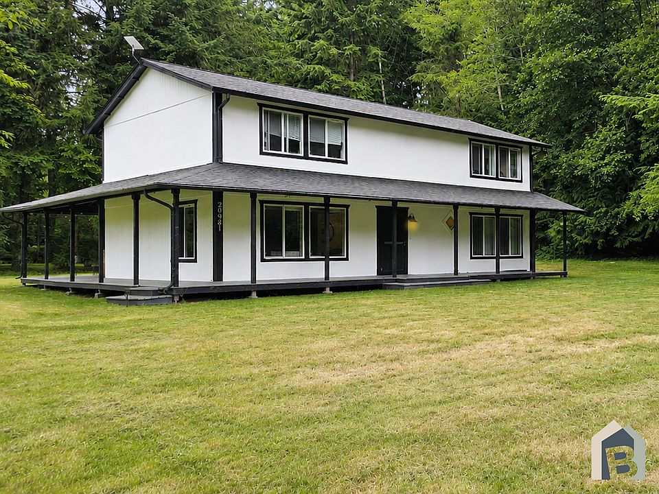 Freshly painted home with large covered wraparound deck and yard