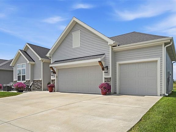 Light gray siding exterior with stone accents