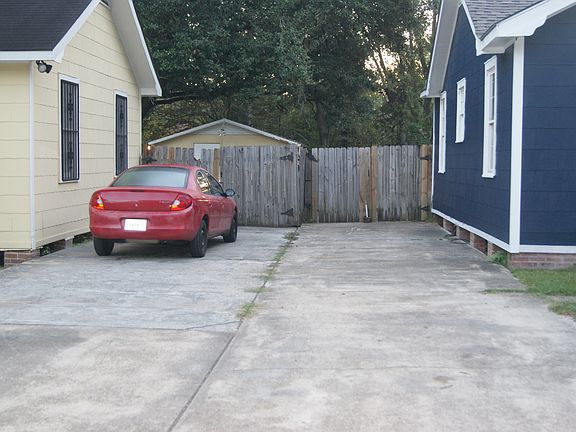 Side driveway leading to the rear of the property _ provides off-street parking and access to the backyard.
