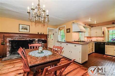 Spacious kitchen with pine floors  and dining area; upgraded counters with wooden counters. .