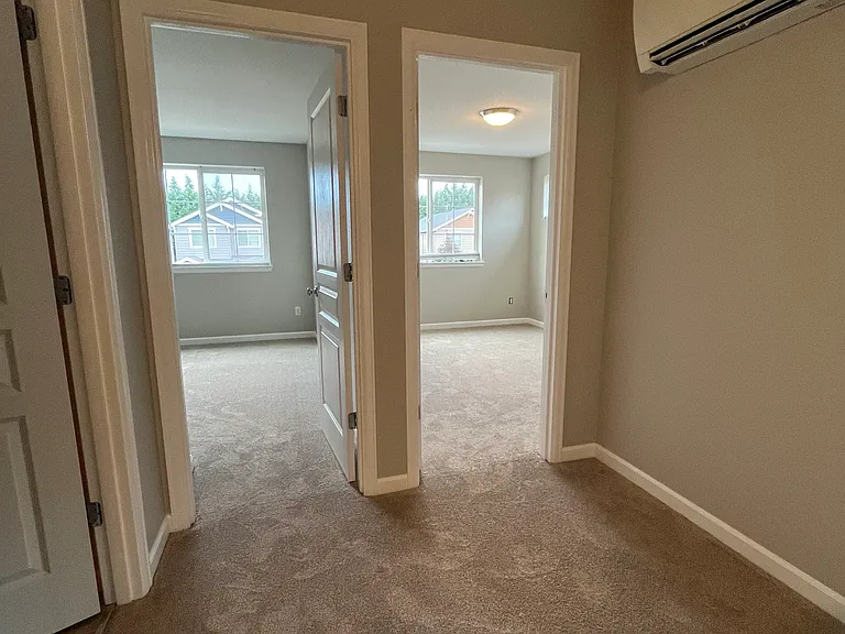 Upstairs, top of stairs showing 2 bedrooms, bathroom to the left, and minisplit