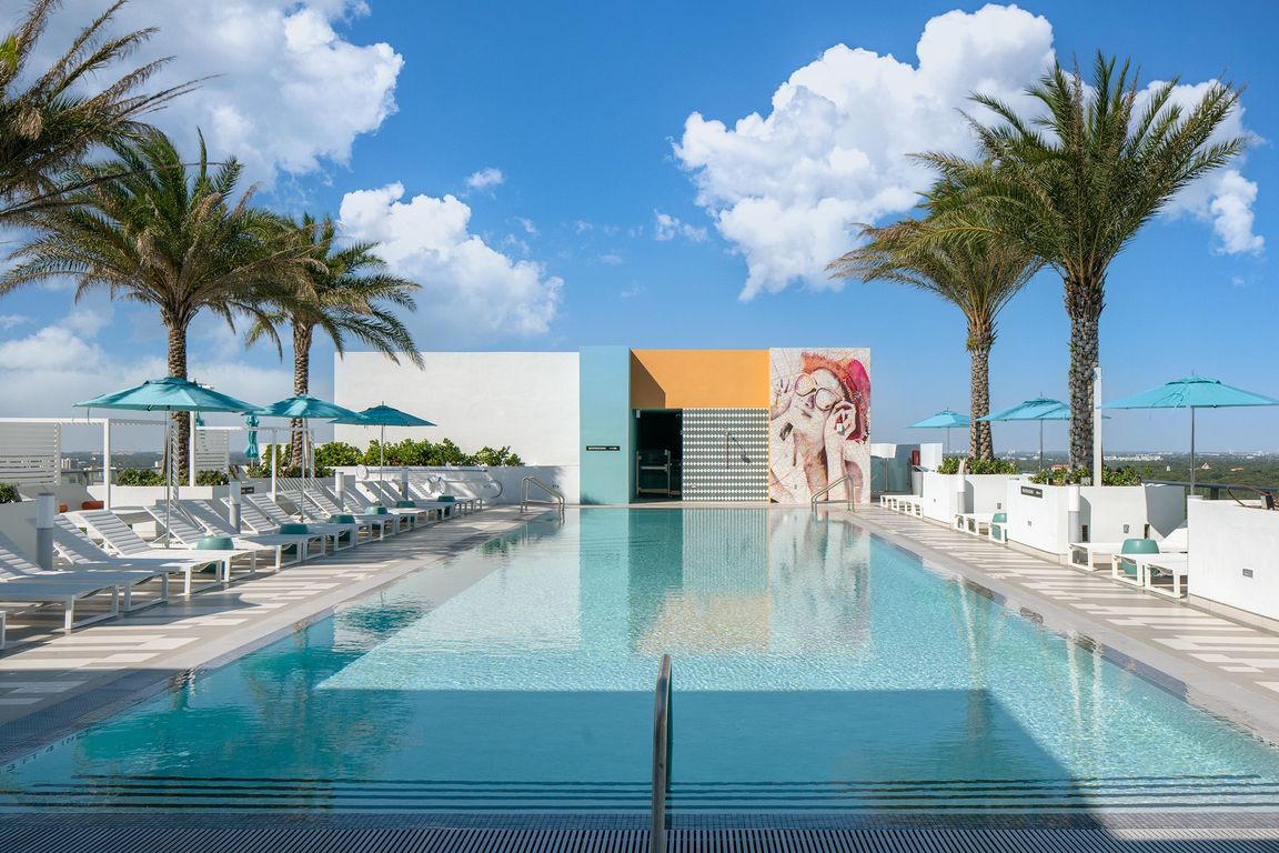 Enjoy our serene rooftop pool oasis with cabanas and lawn space