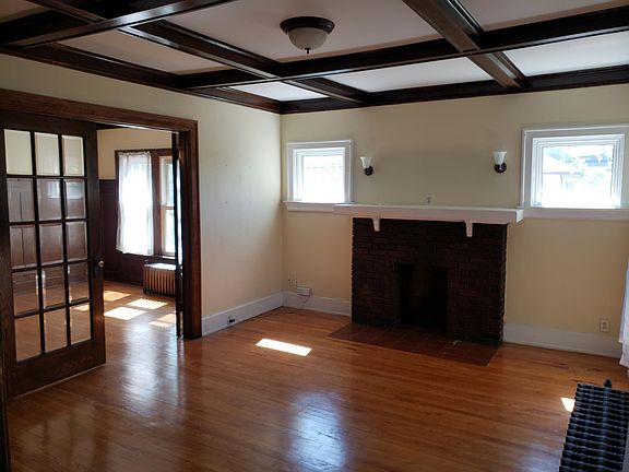 Living Room facing Southwest. Beveled glass french doors connect to Dining Room.