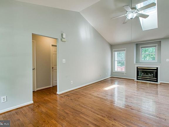 Family Room with Vaulted Ceiling, Skylight and FP