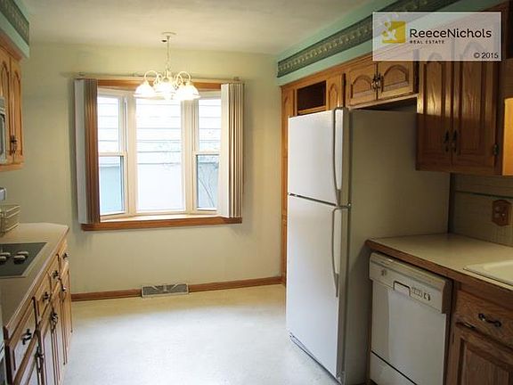 Cozy Eat In Kitchen with built-in book case & bow window.  Opens