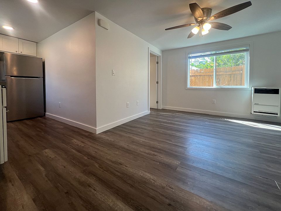 The front door opens to an open living room and the kitchen off to the left hand side