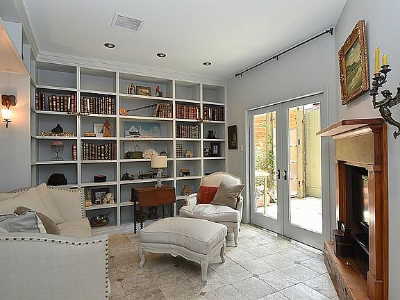 This cozy library/study enjoys access to the inviting patio. Travertine tiles flow from inside to out.
