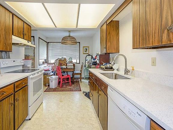 Kitchen with full size Oven, Dishwasher, and Refrigerator. Dining Area off kitchen.