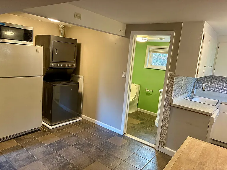Lower level fridge, washer/dryer, entrance to bathroom