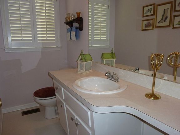 Hall Half Bath located between kitchen and family room.