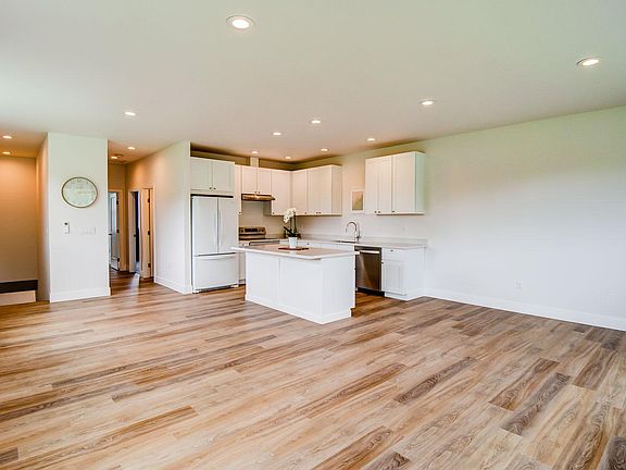 Large open concept living area with kitchen tucked in the corner