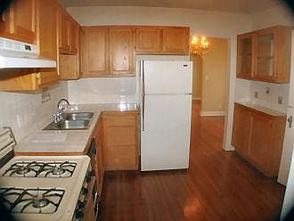 Kitchen with gas range, dishwasher, refrigerator.