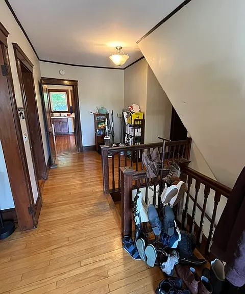 Main foyer as you enter the apartment. This level has kitchen, living room, dining room, bathroom, 2 bedrooms, small room/office and access to front porch.