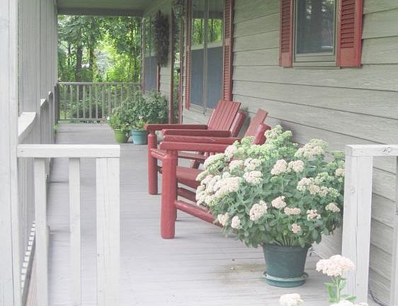 The welcoming front porch just invites you take a seat and watch nature at it's best.